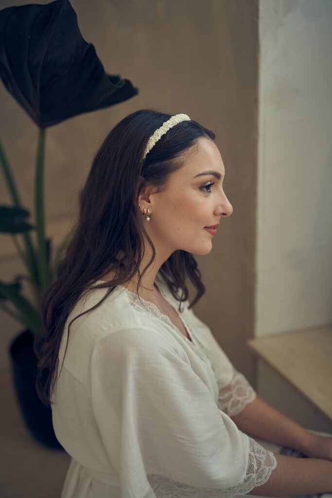 Hochzeitsfotograf NRW 2 Braut sitzt nachdenklich beim getting ready auf einem Stuhl.
